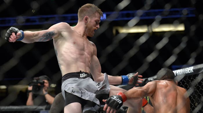 August 17, 2019; Anaheim, CA, USA; Cory Sandhegen moves in with a knee hit against Raphael Assuncao during UFC 241 at Honda Center.